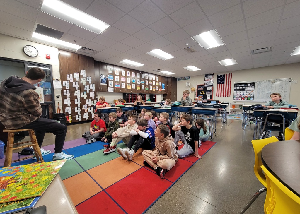 Dane reading to a group of students.  