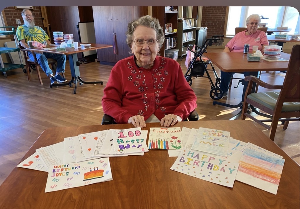 Joyce smiling with her cards.
