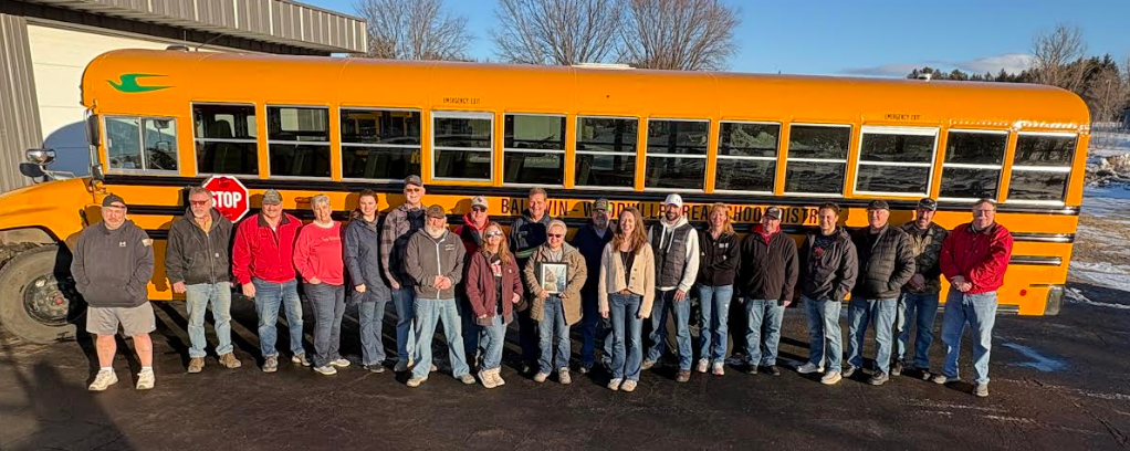 Bus and van drivers in front of the bus.