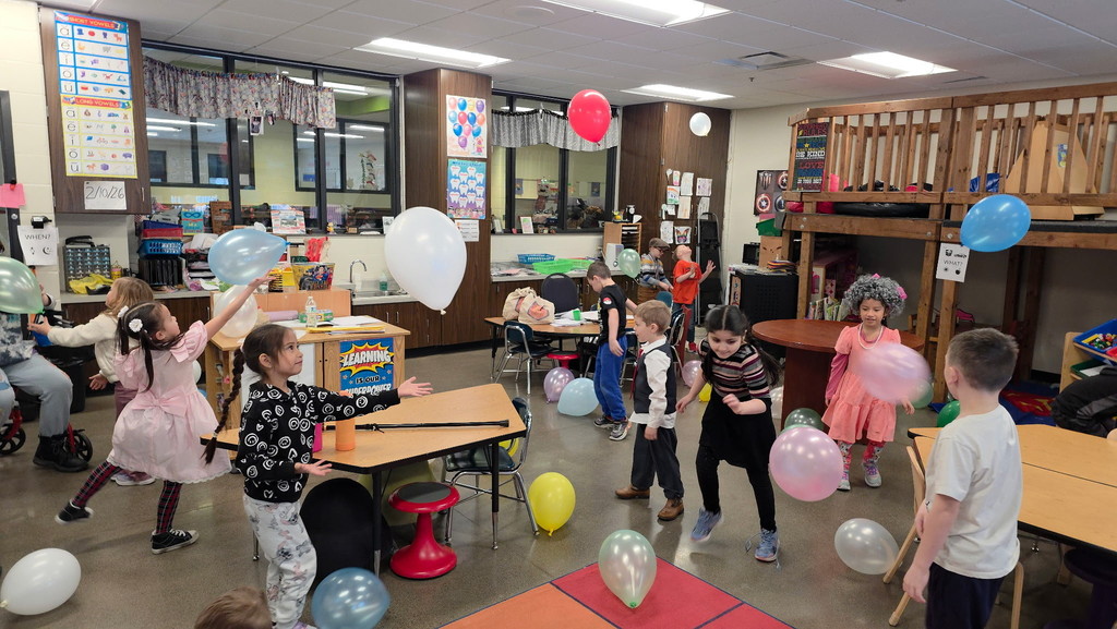 Kindergartners playing with balloons.