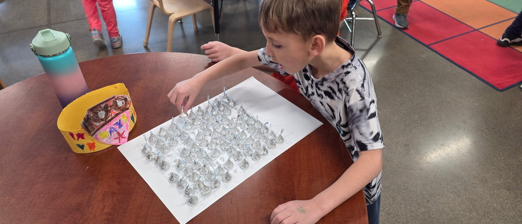 Student counting 100 candies.