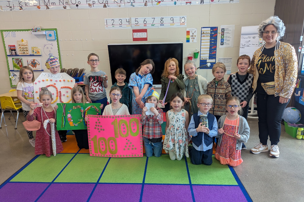 Students with their teacher on the 100th day.