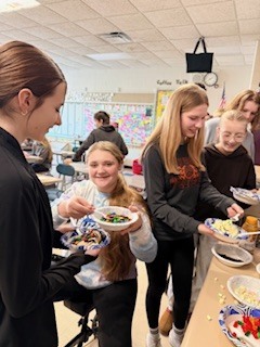 Students smiling with their ice cream treats.