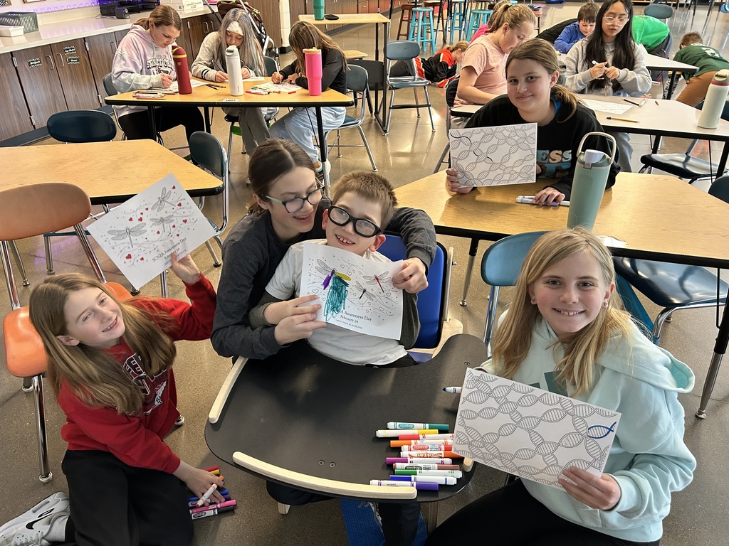 Students showing off their art work.