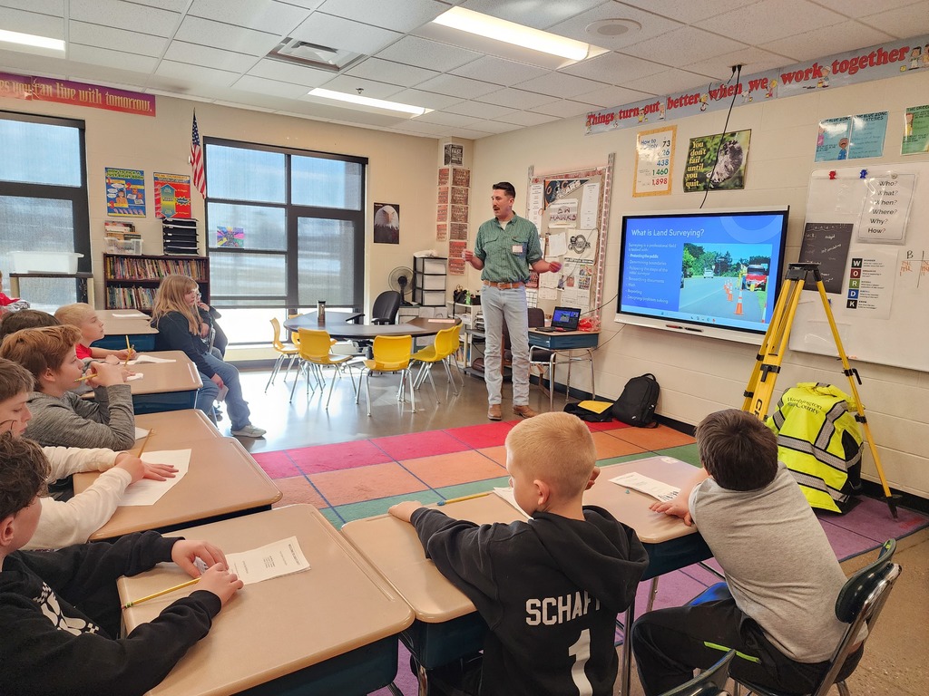 A surveyor presenting to students.