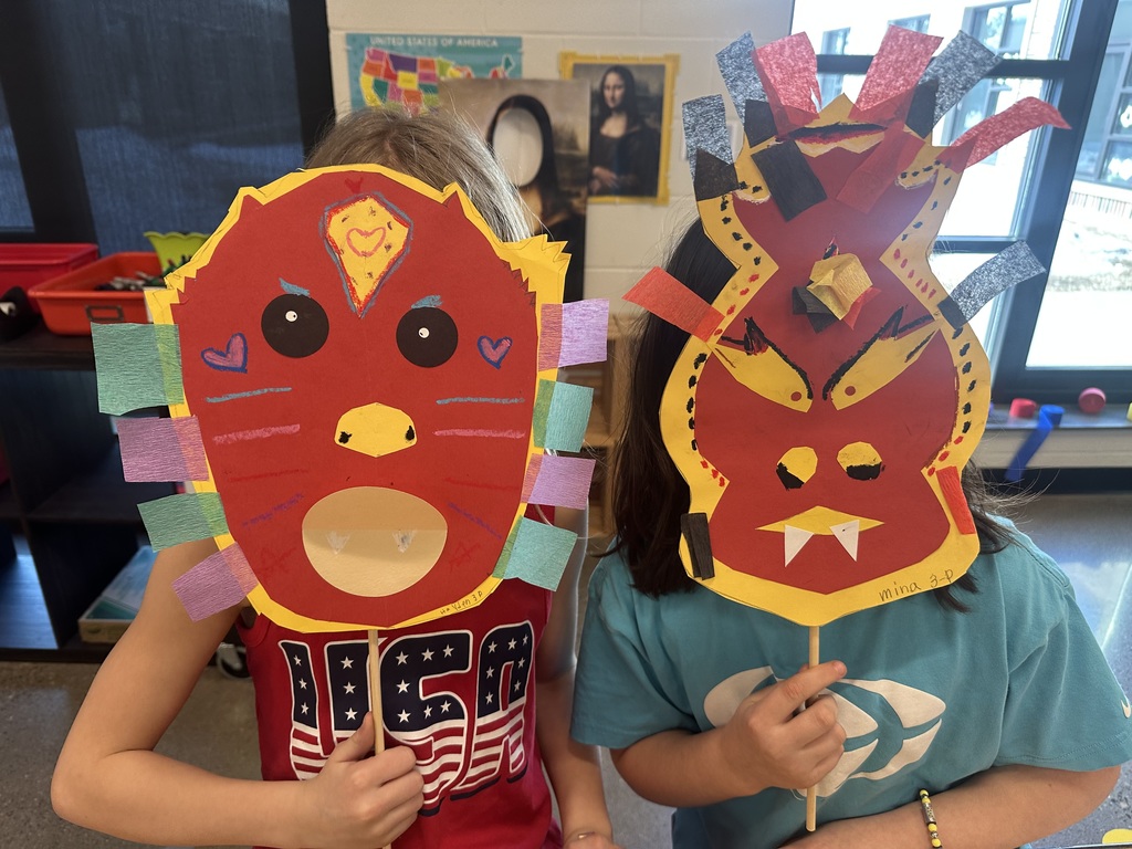 Colorful dragon masks of two students.