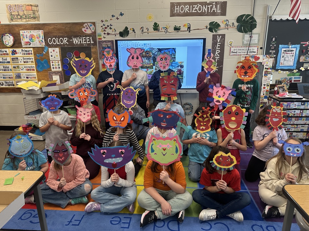 Class picture of students with masks in front of their faces.