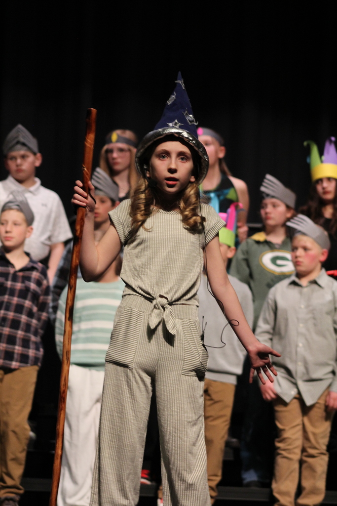 A girl as a wizard performing her solo.