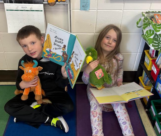 Two students reading and smiling.