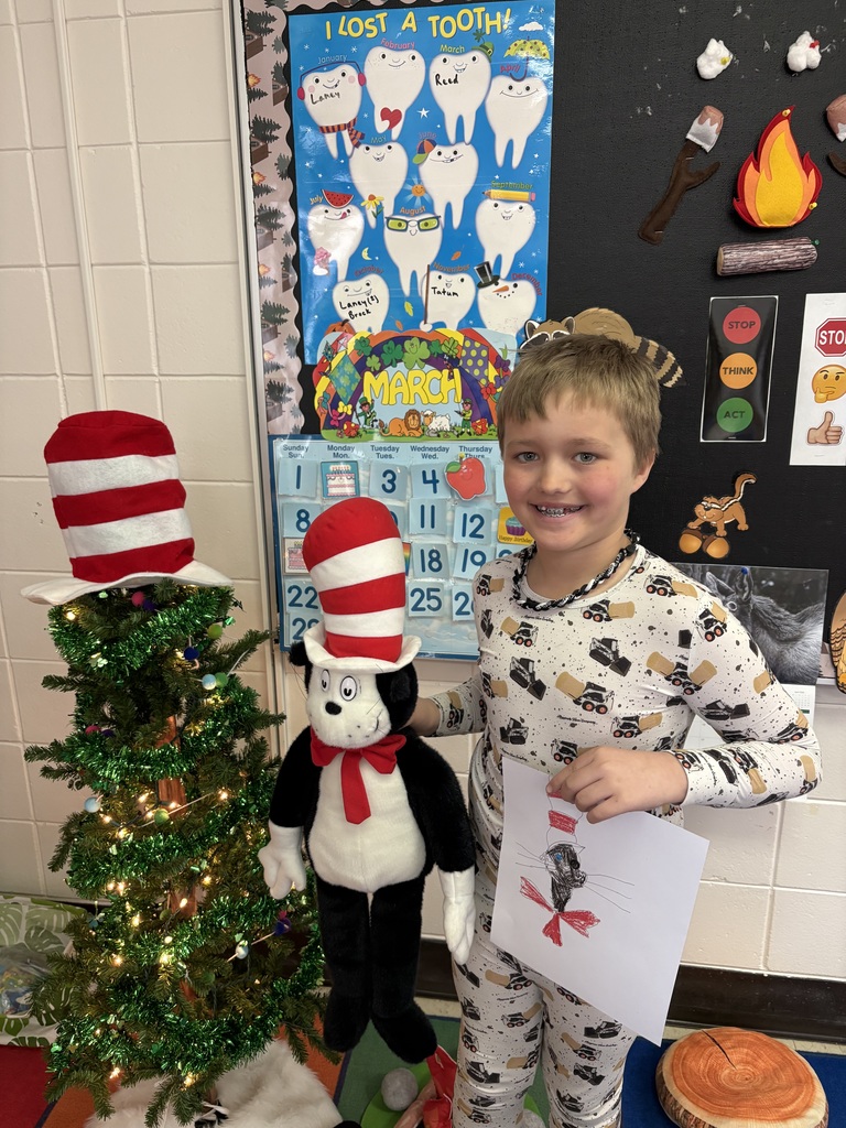 Student with a stuffed animal and their drawing.