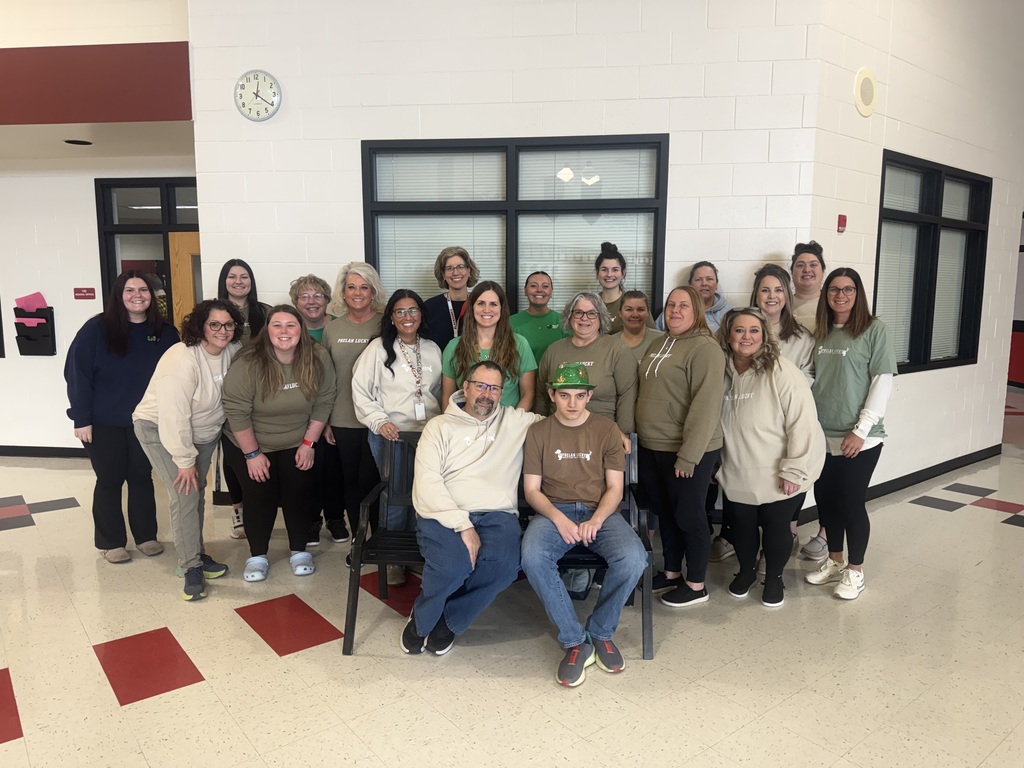 Group photo of high school staff and Lucas.