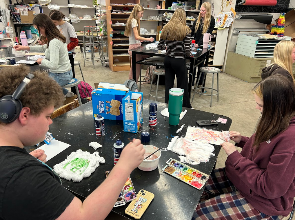Picture of students in the art room working on a project.