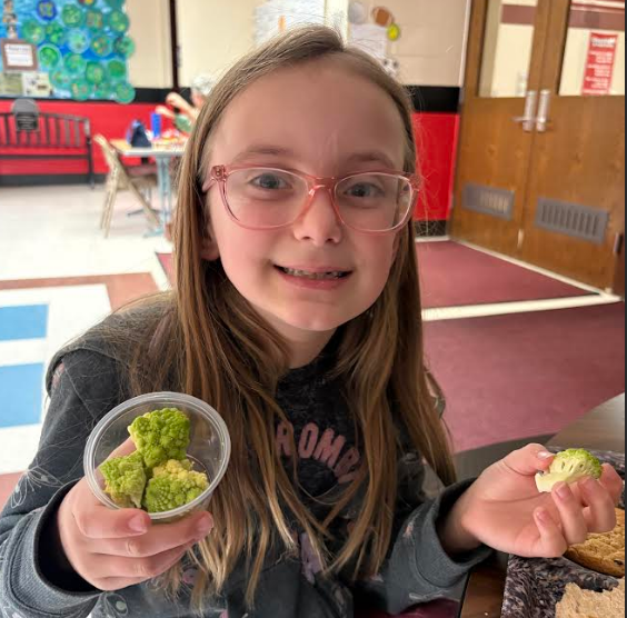 Student smiling and showing the Romensco.