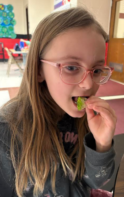 Student trying the veggie!