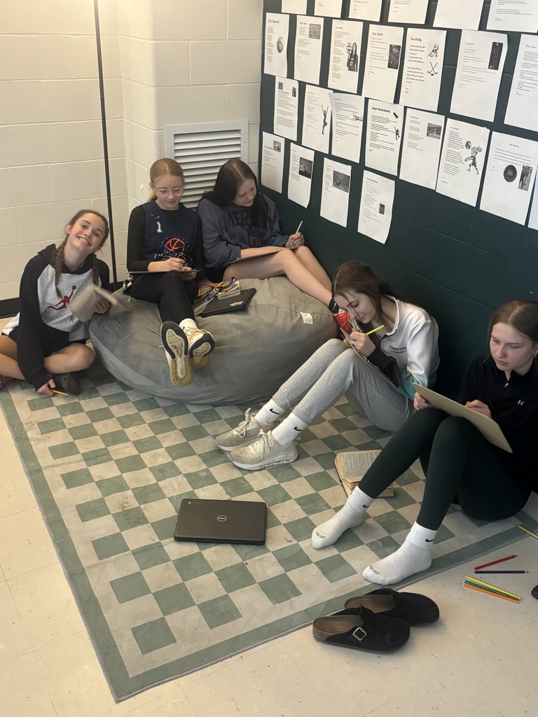 Students sitting together drawing.