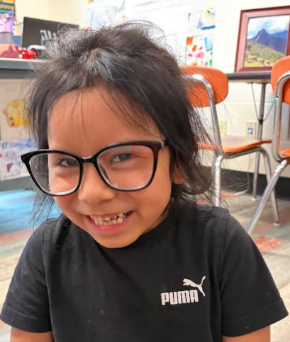 Student giggling while wearing glasses.