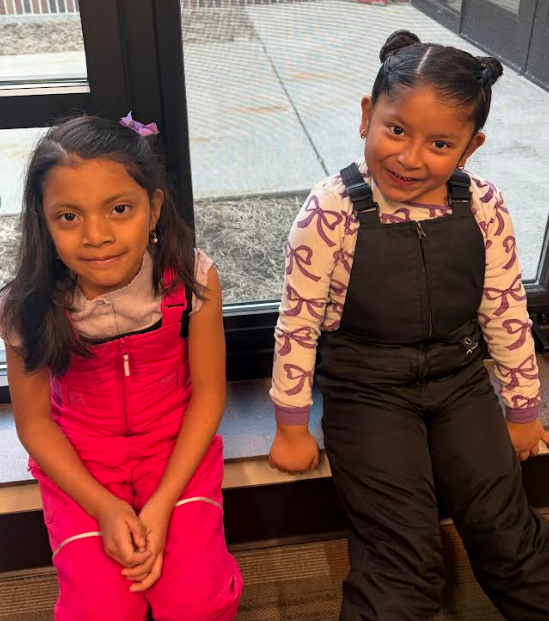 The first photo shows two girls in their pink and black snow bibs.