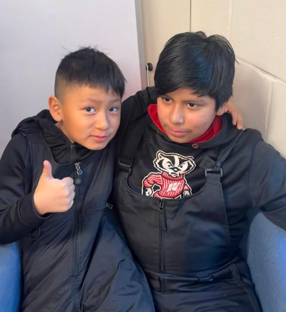 The second photo shows two boys, including one giving a "thumbs up" and wearing a Bucky Badger hoodie.