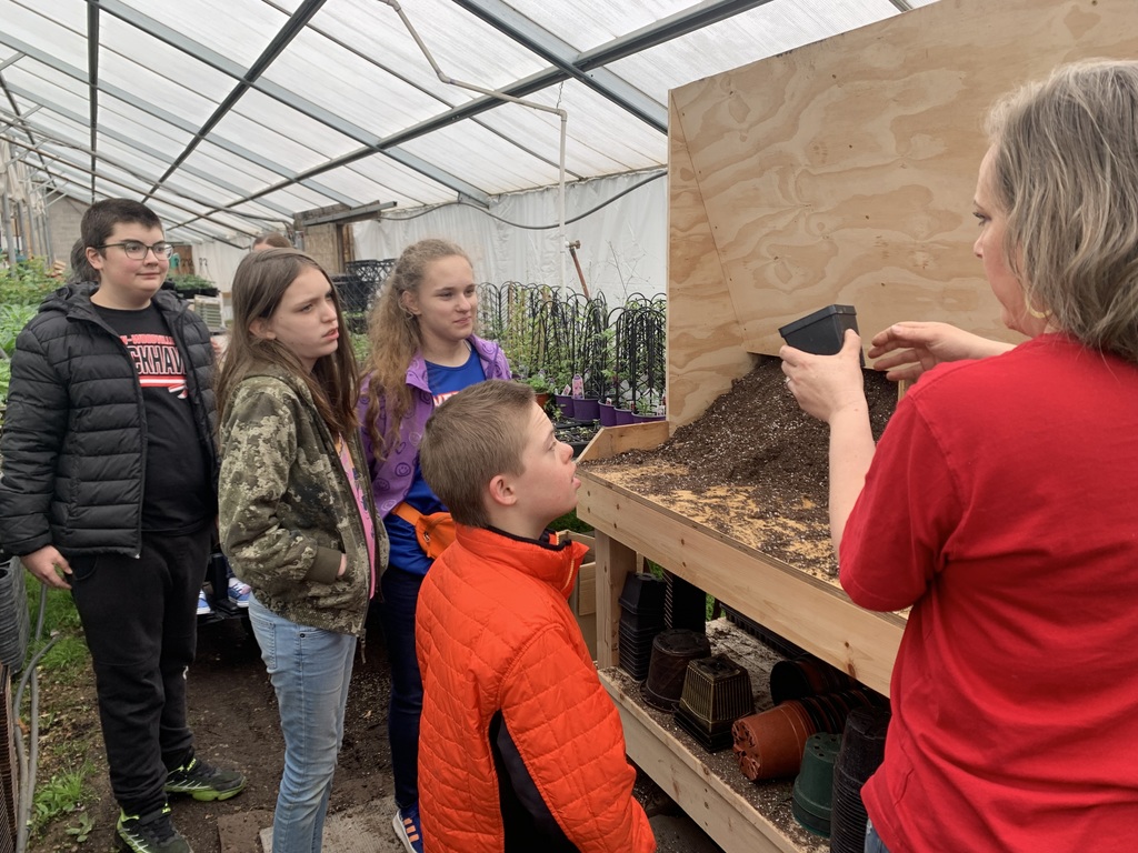 Annette at the Greenhouse talking to students about flowers.