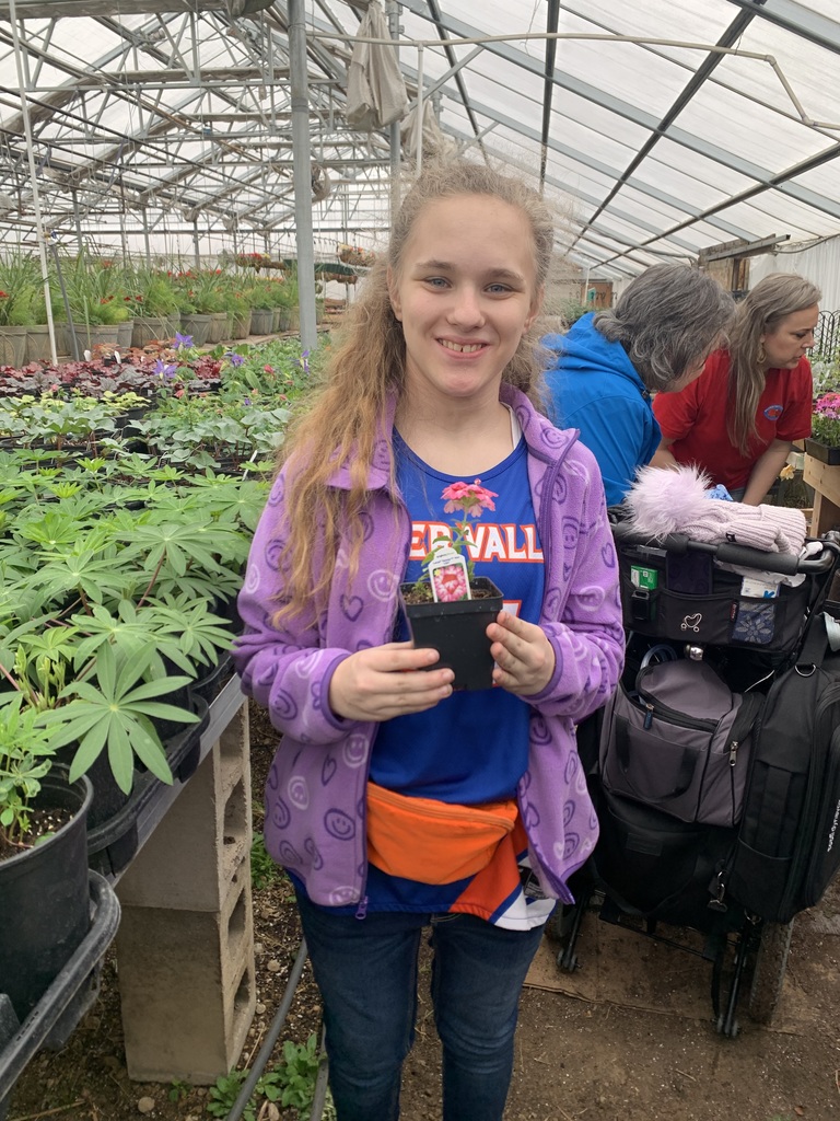 A girl smiling in the Greenhouse.