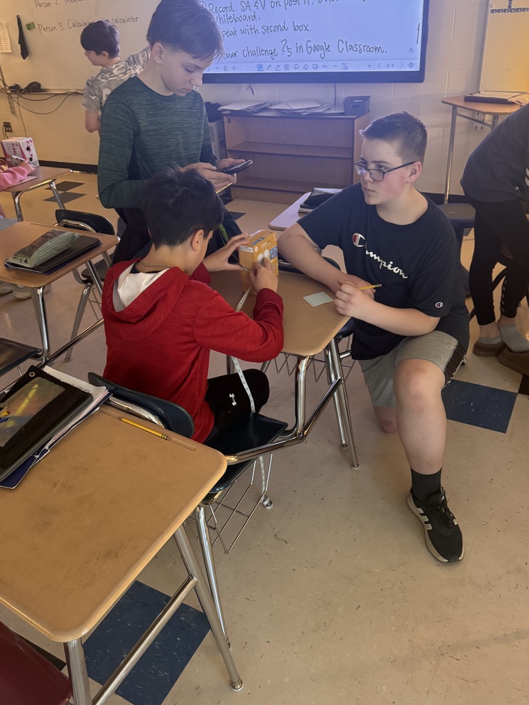 Three students working together in math class.