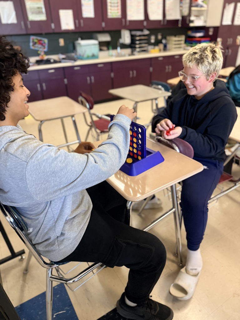Students smiling while playing a game.