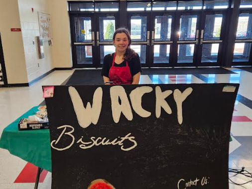 A student smiling with her "food truck"  WACKY BISCUITS