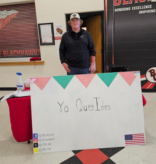 A student smiling with his "food truck" YO QUESIDEA
