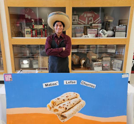 A student smiling with his "food truck" MATIAS' LEFSE CHURROS