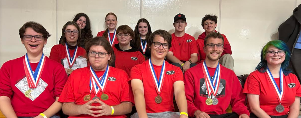 Team photo from the Science Olympiad. All students are smiling with their medals.