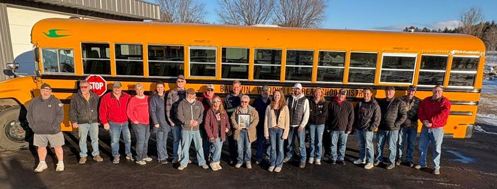 BWSD Bus Drivers standing in front of a bus.