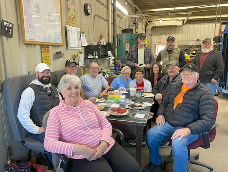 Bus drivers enjoying pie.