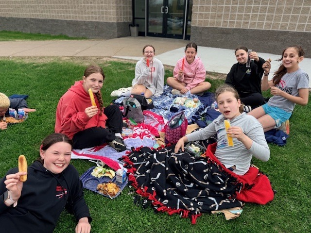 Group of students posing with their lunch.