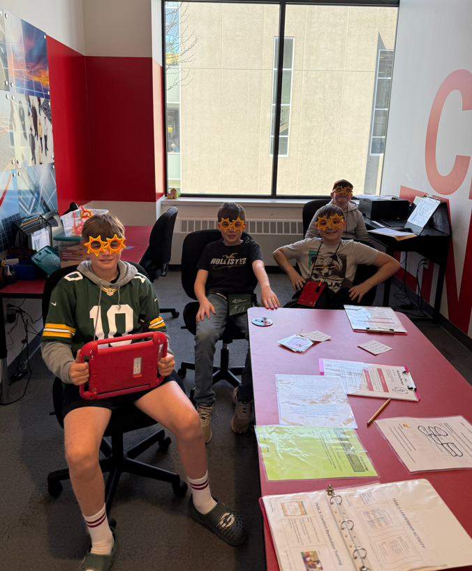Four students working around a table.