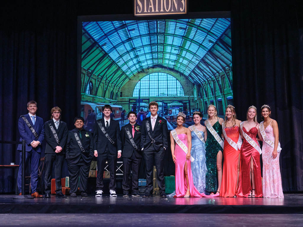 Prom Court on stage smiling.