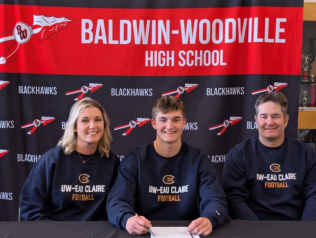 Brody and parents smiling and signing.