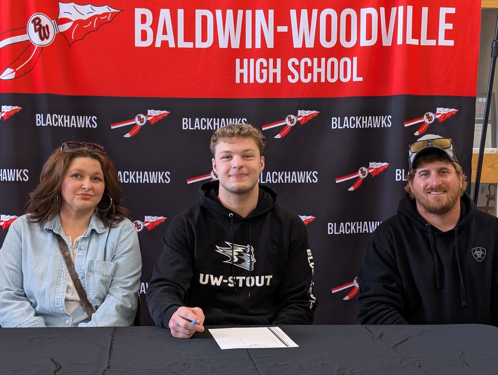 Trevor and parents smiling.