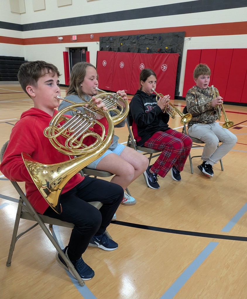 A group of students with a variety of instruments.