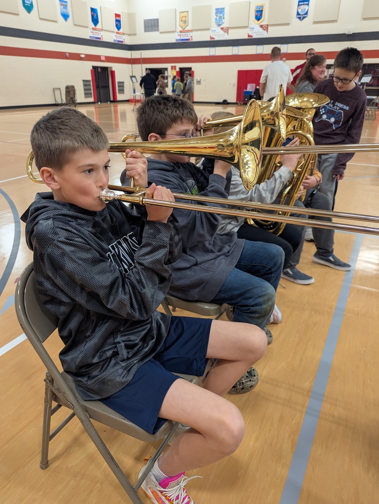Students trying out saxophones.