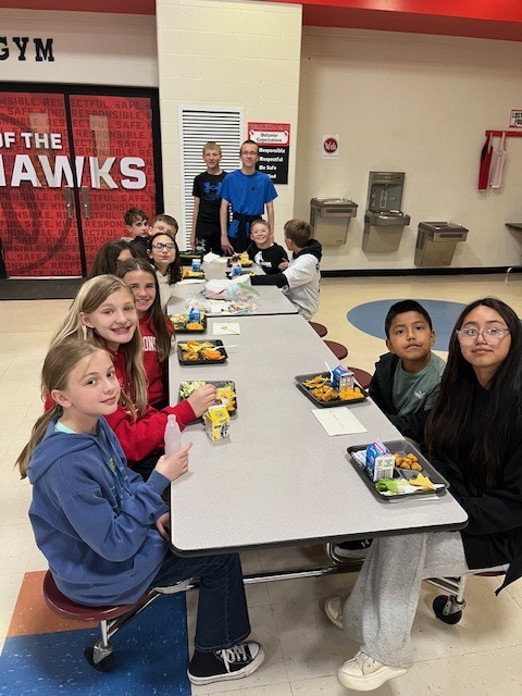 A group of smiling 5th graders