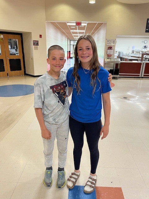 A brother and sister smiling during the tour.