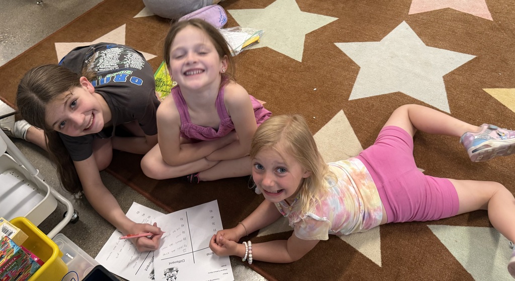 A group of girls on the carpet smiling