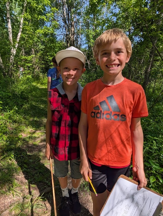 Two students smiling in the school forest