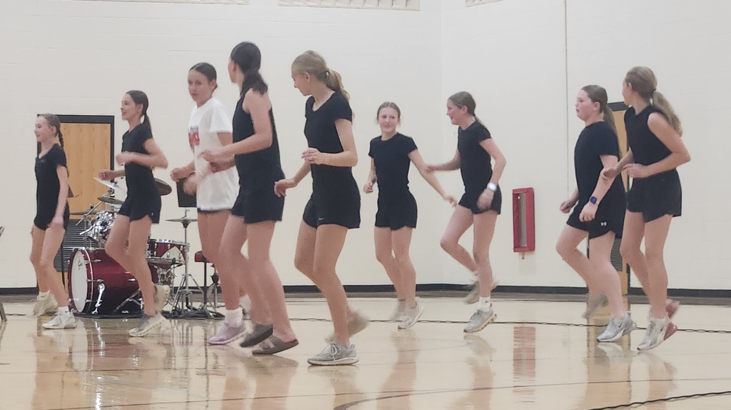 A group of girls dancing at the talent show.