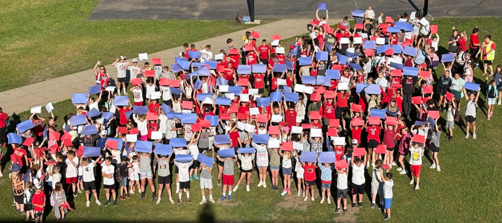 Students with Red White and Blue papers