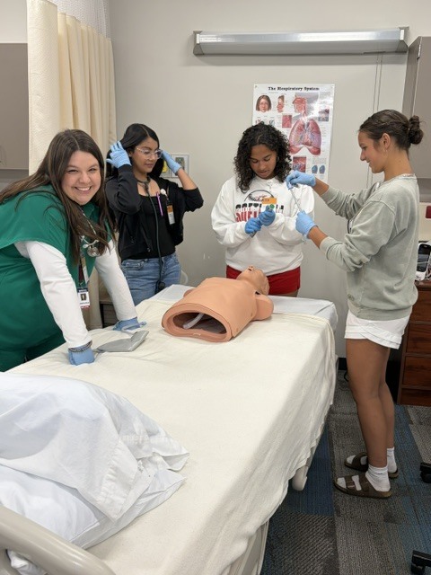 Students working on a simulated patient.