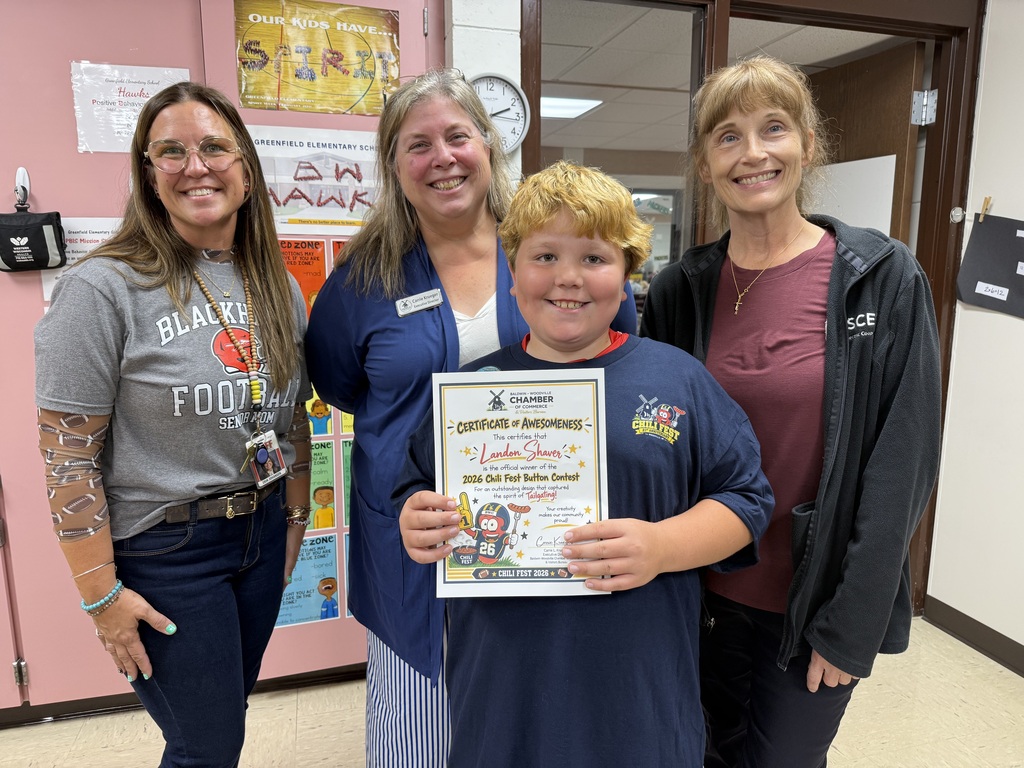 Fourth-grader Landon smiling proudly in the center, flanked by three adults, while holding his official "Certificate of Awesomeness" award for winning the 2026 Chili Fest Button Contest.