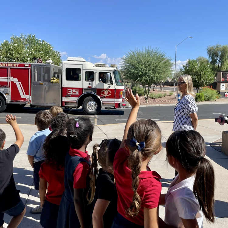 kids waving to fire truck 