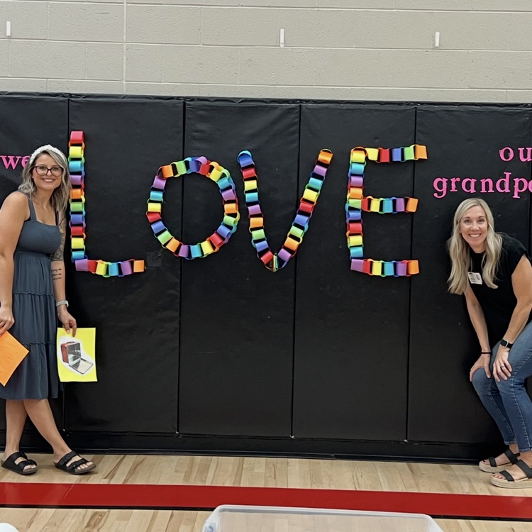 parents posing with a sign 