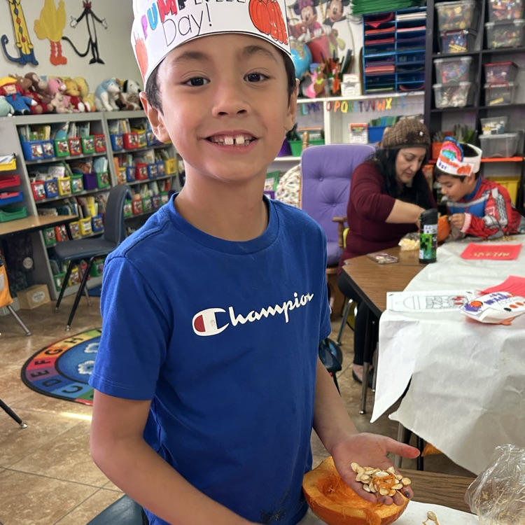 child with pumpkin
